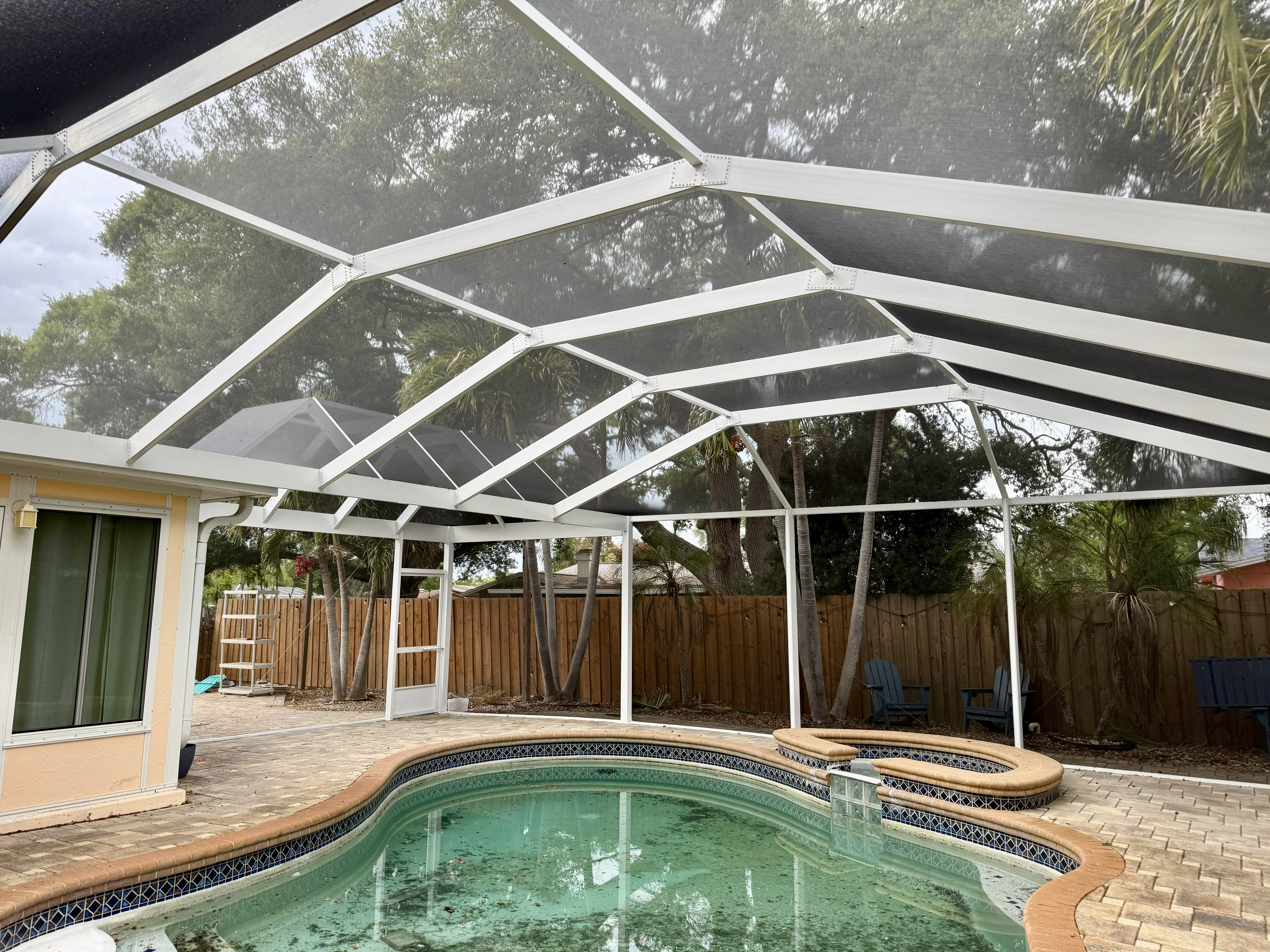 Completed pool cage enclosure in Ruskin, FL after replacement by Top Tier Home Building Solutions