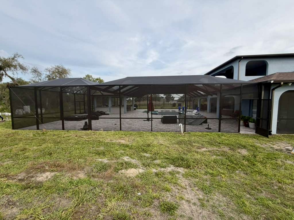 Exterior side view of a large completed mansard pool cage in Brooksville, Hernando County, FL